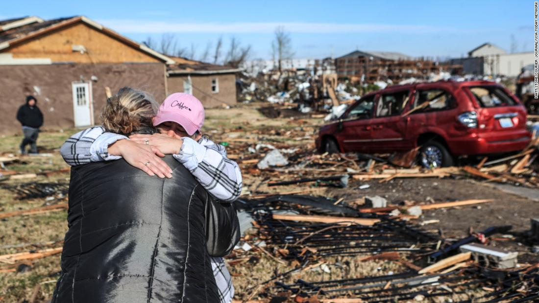 Irene Noltner, in a pink hat, consoles Jody O&#39;Neill outside The Lighthouse, a women and children&#39;s shelter that was destroyed in Mayfield.