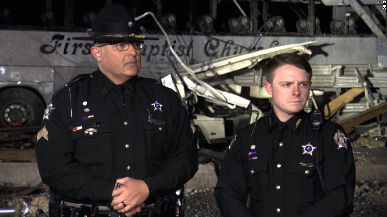 Two officers survived a tornado that battered their patrol cars. They escaped and saved an injured girl