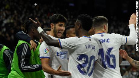 Marco Asensio celebrates with teammates after scoring the game&#39;s second goal. 