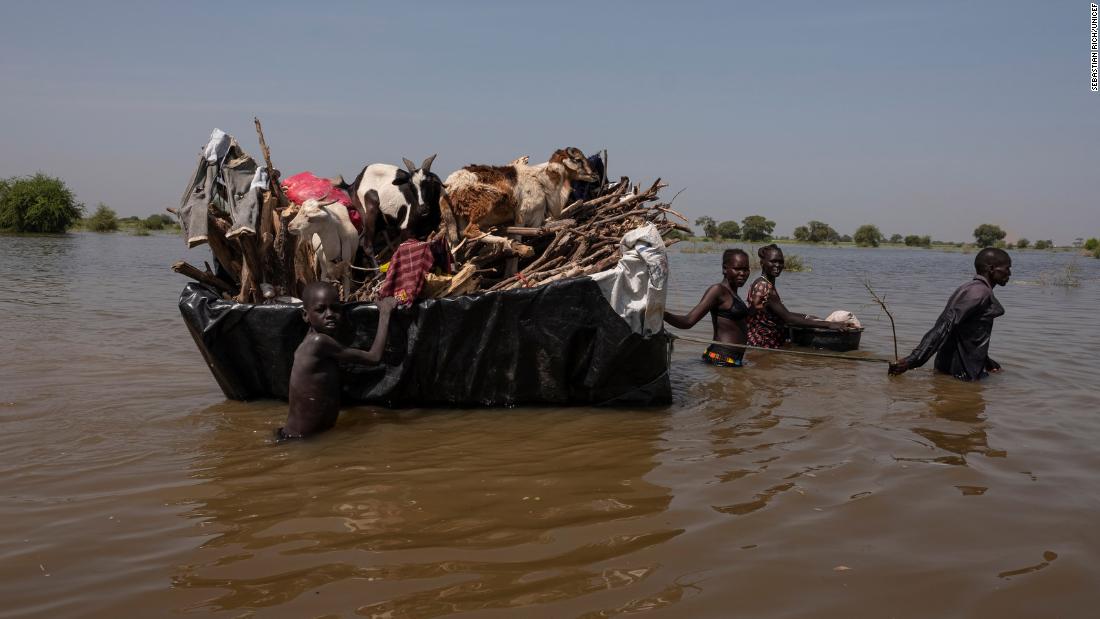 A family pulls their possessions and livestock on a homemade raft. Rich met this family after they had traveled 20 kilometers (about 12.4 miles). They were tired and hungry, Rich said, and the father in the family told him: &quot;Only 5 kilometers (3.1 miles) to go.&quot;