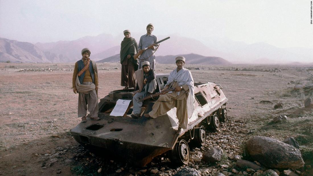 Afghan rebels are seen on top of a knocked out Russian armored vehicle in Afghanistan in February 1980. The Soviet Union invaded Afghanistan in 1979 as communist Babrak Karmal seized control of the government. US-backed Muslim guerrilla fighters waged a costly war against the Soviets for nearly a decade.