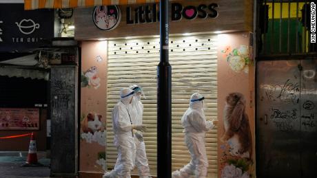 Hong Kong government workers investigate the Little Boss pet store on January 18.