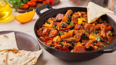 This spicy pork stew with chorizo and black beans is perfect served with tortillas and orange slices.