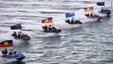 Jetskis fly the Australian and Aboriginal flags during Australia Day celebrations in Sydney on January 26, 2021. 