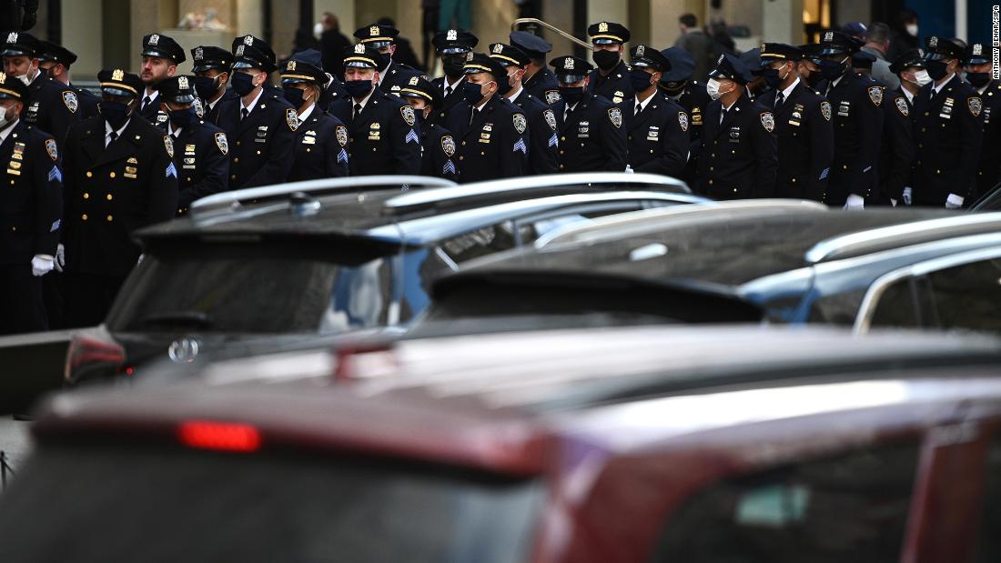 Members of the New York Police Department stand in formation outside St. Patricio&#39;s Cathedral as they attend Rivera&#39;s wake on Thursday.