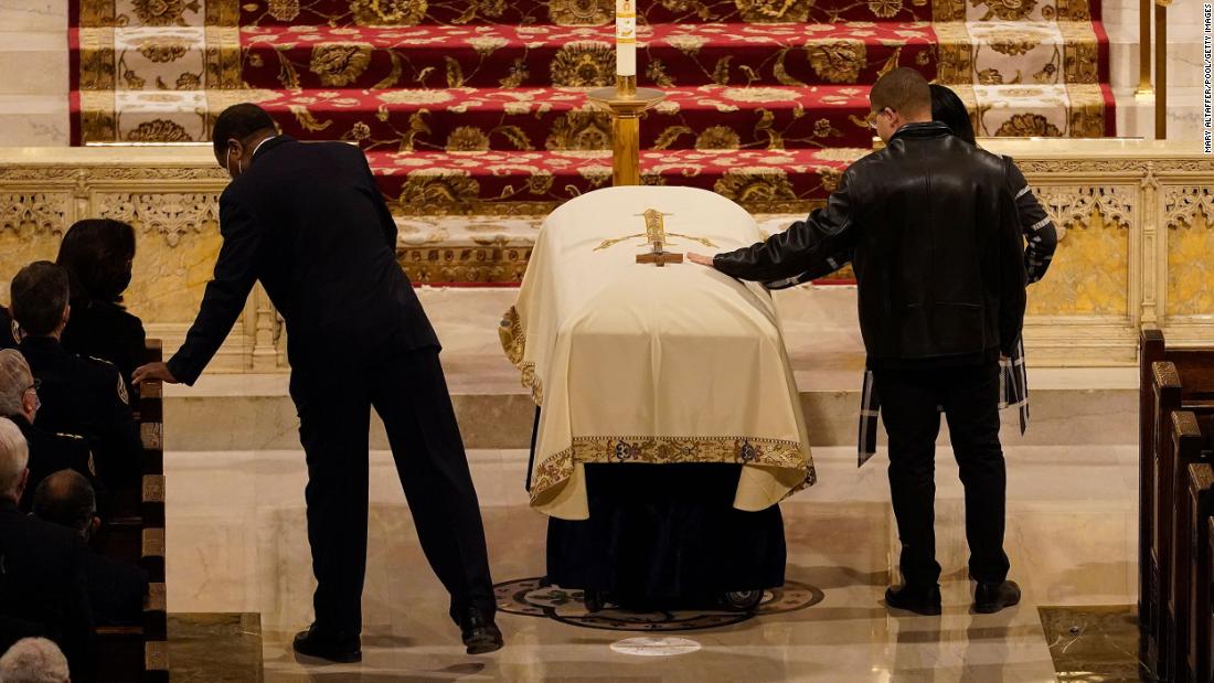 Family members touch Rivera&#39;s casket during his funeral.