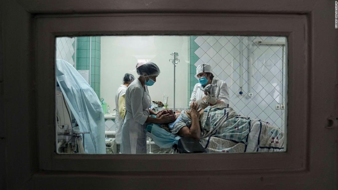 Medical workers show a mother her newborn after she gave birth at a maternity hospital in Mariupol on March 1. The hospital is now also used as a medical ward and bomb shelter.