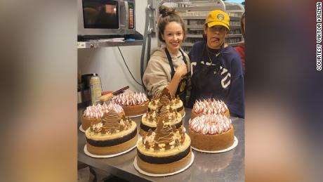 Laika Cheesecakes and Espresso business owner Anna Afanasieva with one of her team members and their cakes. 
