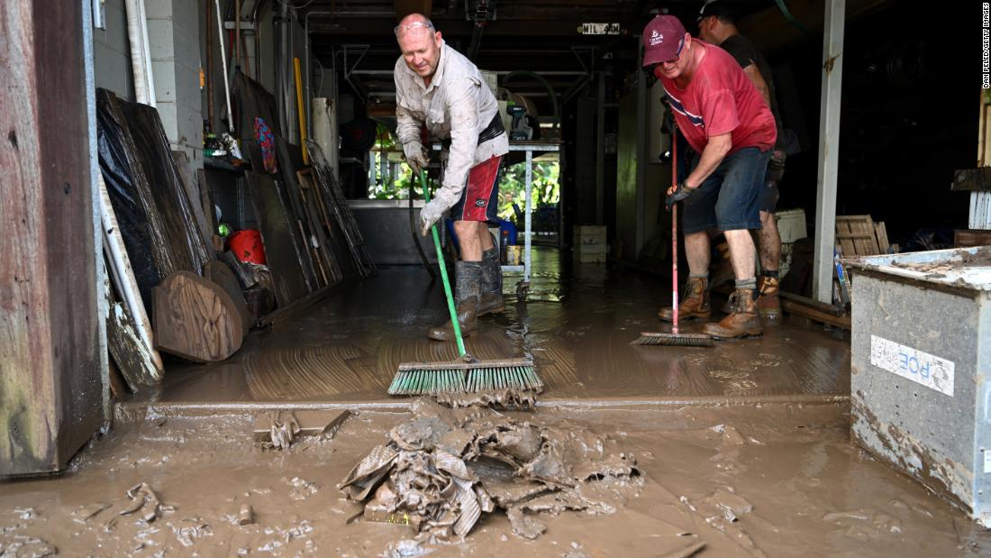 Craig Ashcroft, left, and Rob Beenhakker clean up a friend&#39;s home in Tumbulgum, Australia, on March 6.