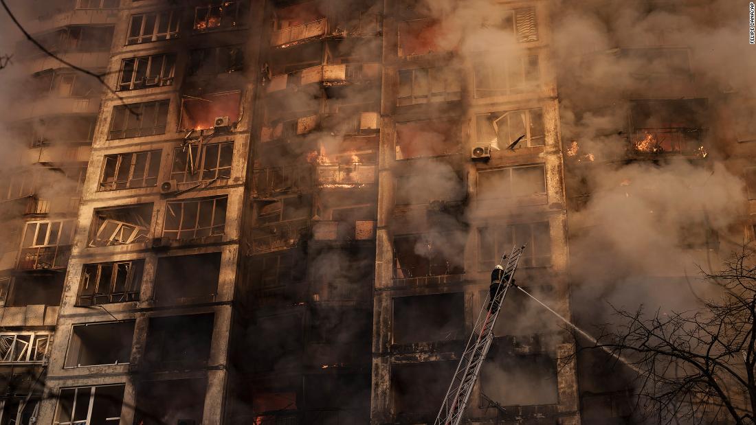 Firefighters work to extinguish flames at an apartment building in Kyiv on March 15.