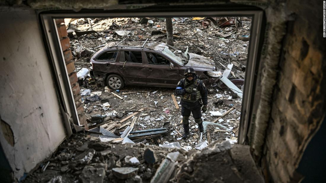 A Ukrainian serviceman stands among debris after shelling in a residential area in Kyiv on March 18. 