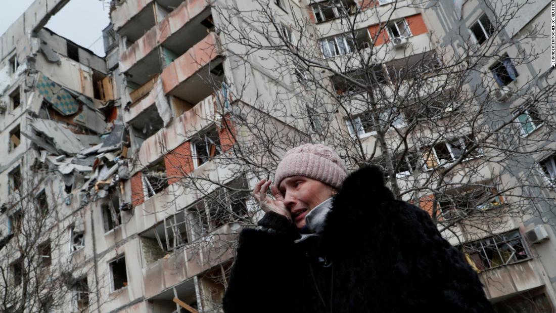A woman reacts while speaking outside a destroyed apartment block in Mariupol on March 17.