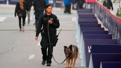 A Los Angeles Police Bomb Detection female officer with her K-9 dog.