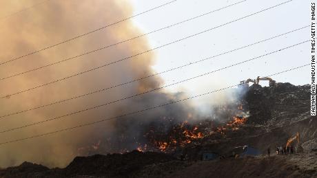 Indian firefighters battle Delhi landfill blaze as air fills with toxic fumes 