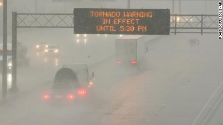 The Mississippi Department of Transportation warns drivers along I-55 southbound in Jackson of a tornado warning during a rainstorm during the outbreak of severe weather in the state on Wednesday. 
