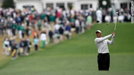 Woods watches his second shot on the first fairway during the third round at the Masters.