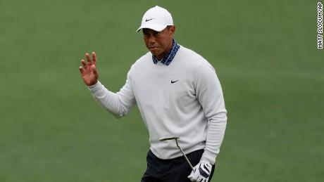 Woods waves after a birdie putt on the second hole during the third round at the Masters.