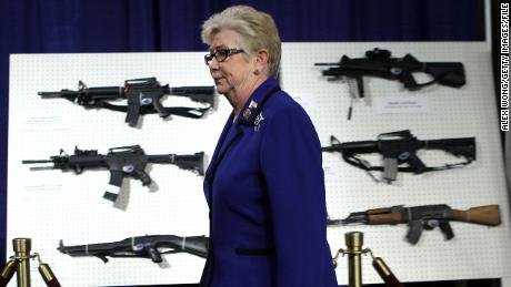 Former US Rep. Carolyn McCarthy passes by a display of assault weapons during a news conference January 2013 on Capitol Hill in Washington, DC.