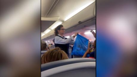 See airline passengers throw away masks as mandate is revoked
