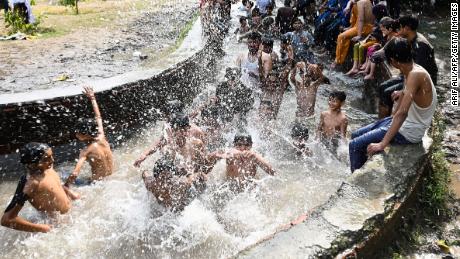 People cool themselves in a canal in Lahore, Pakistan, on April 29. 