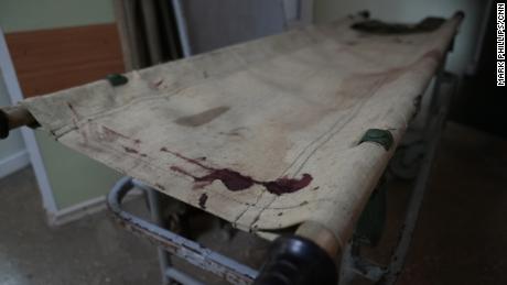 A bloody gurney lies in the hallway of a hospital in Bakhmut.