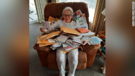 Margie poses with the letters she&#39;s received from Love For Our Elders. 