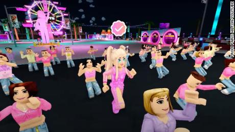 Paris Hilton&#39;s avatar joins a dance party at the Neon Carnival in Paris World on Roblox, the virtual gaming platform