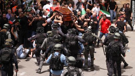Family and friends carry the coffin of Al Jazeera reporter Shireen Abu Akleh, who was killed during an Israeli raid in Jenin in the occupied West Bank, as clashes erupt with Israeli security forces, during her funeral in Jerusalem on May 13.