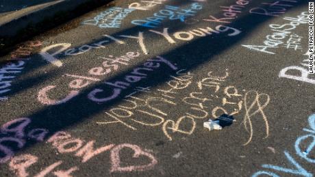 Victims names are written in chalk near the supermarket.