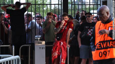 Liverpool fans are held at the gates -- with many feeling the effects of tear gas -- ahead of the Champions League final.