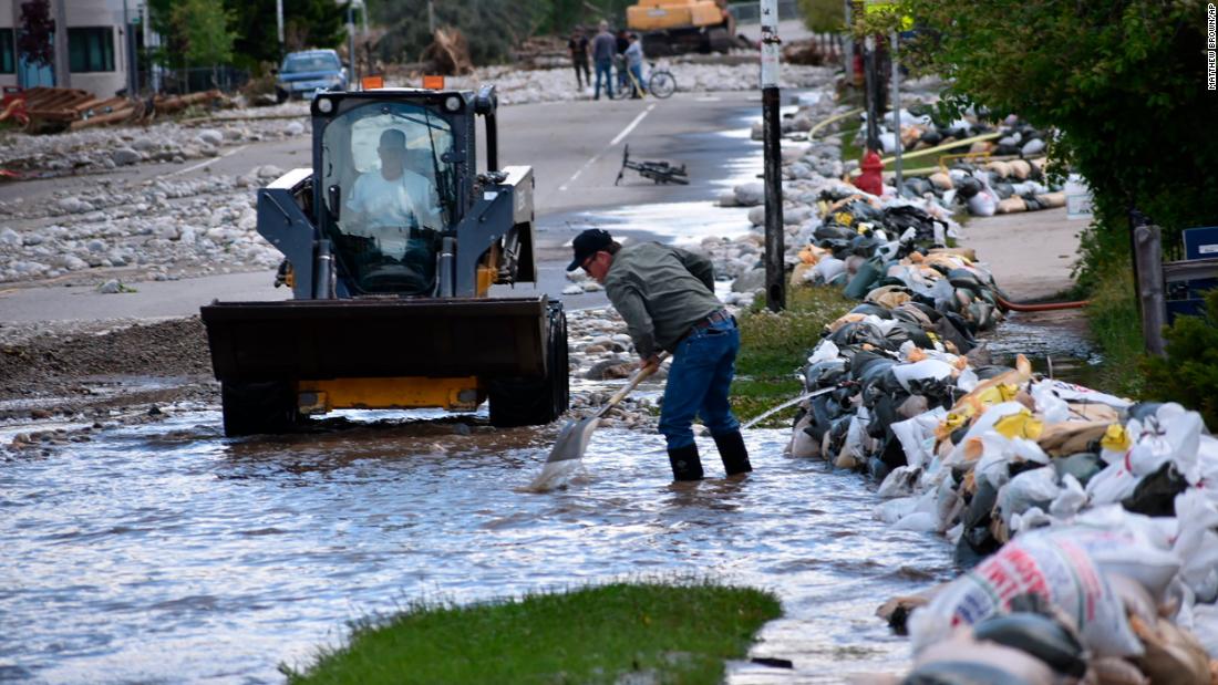 Red Lodge residents clear mud, water and debris on Tuesday.