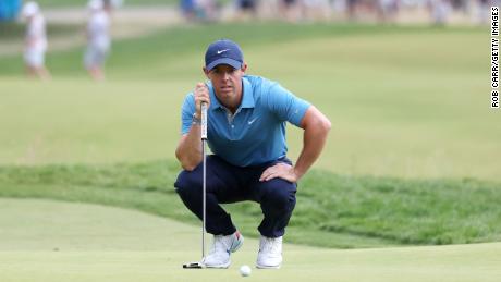 McIlroy lines up his putt on the second green.