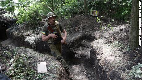 A Ukrainian serviceman walks along an entrenched position on the front line near Avdiivka, Donetsk region on June 18/