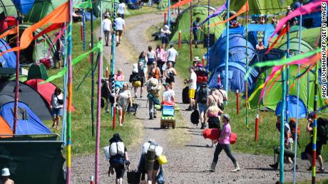 Festivalgoers arrive to attend the Glastonbury festival in the village of Pilton, in Somerset, South West England, on Wednesday.