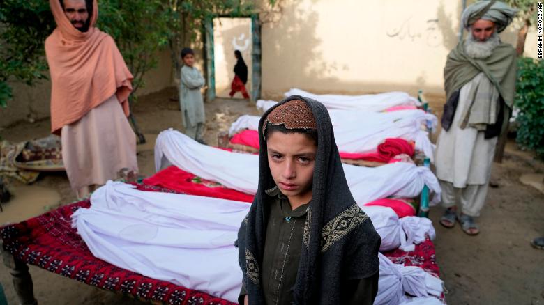 Men stand around the bodies of people killed in an earthquake in Gayan village, in Paktika province, Afghanistan, on June 23.