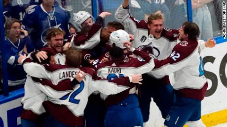 Avalanche players gather at the boards, celebrating their victory in Game 6.