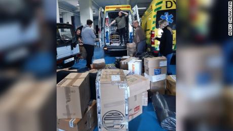 Ukrainian footballer Roman Zozulya and fellow volunteers stuff ambulances to be sent to Ukraine with care packages in Madrid in Spain.