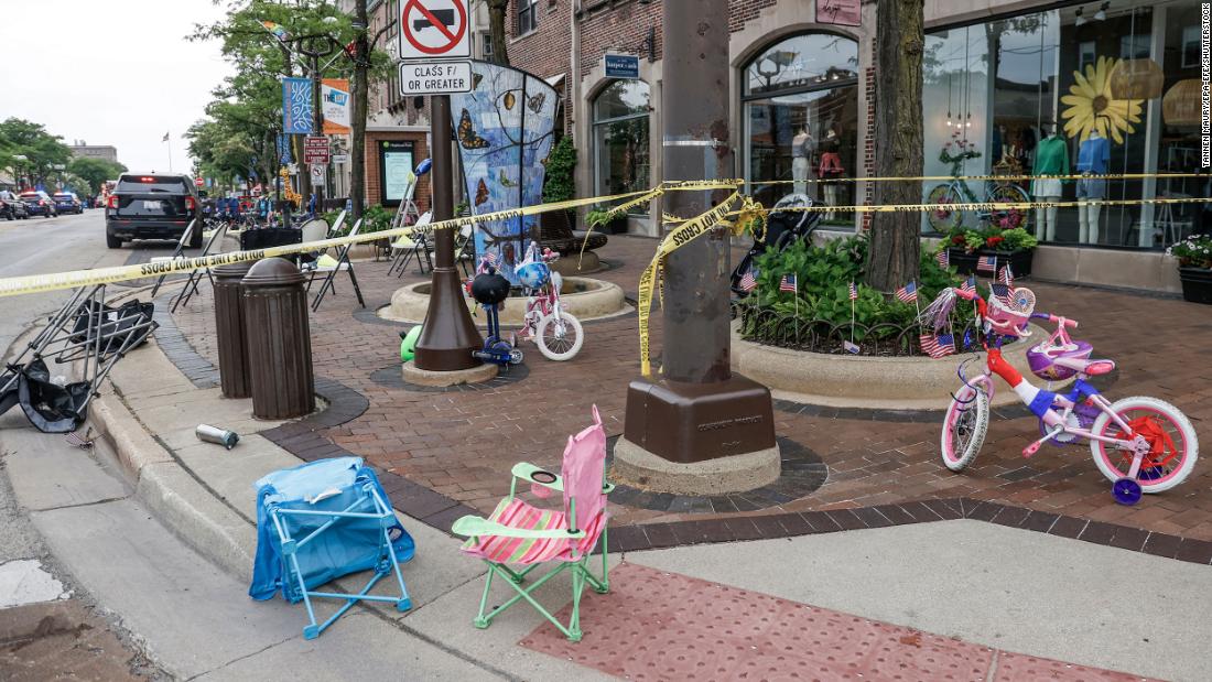Chairs and bicycles lie abandoned after people fled the scene. Police said they recovered a rifle on the roof where they believe the shooter was located.