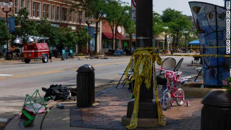 Highland Park, Ill. - July 05:  An abandoned bike and chairs at the intersection of Green Bay Road and Central Avenue on Tuesday, July 5, 2022 in Highland Park, Ill.. On July 4, a gunman fired into the crowd during a parade, leaving at least six dead and dozens wounded. Suspected shooter Robert E. Crimo III is in police custody. (Taylor Glascock/CNN Digital) 