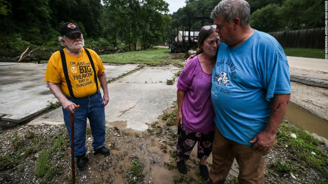 Pastor Pete Youmans consoles a tearful Debby Miniard as her father, Charles Blankenship, stands near where his garage used to be in Perry County. Blankenship lost everything, including his trailer home.