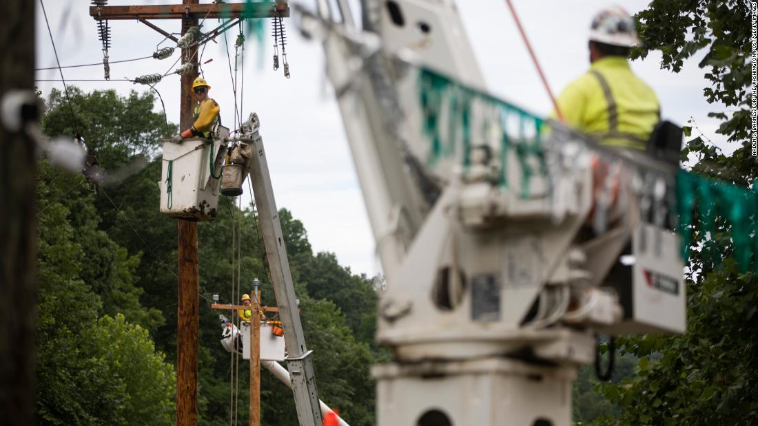 Crew members work to restore power lines near Hindman on Saturday. 