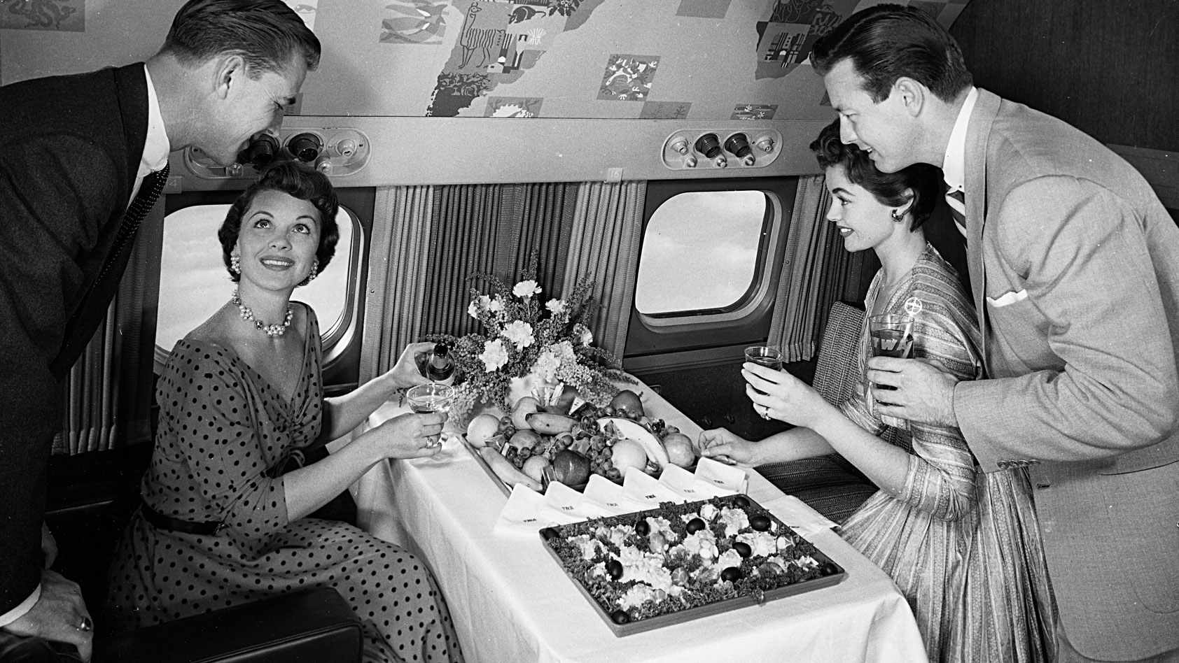 Travelers are served a buffet on board a Lockheed Super Constellation while flying with former American airline Trans World Airlines (TWA) in 1955.