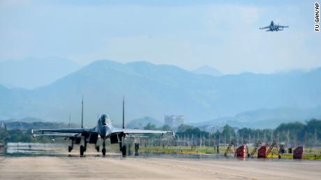 Chinese air force and naval aircraft fly at an unspecified location in China on August 4.