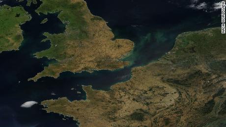 A satellite image showing parts of England and France, scorched brown by drought and heat. 