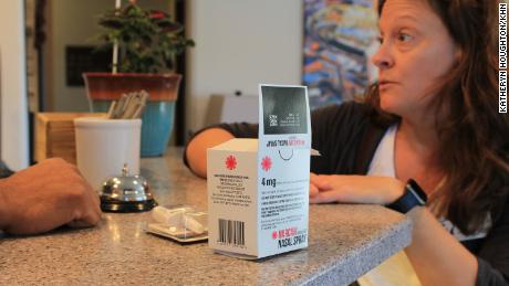 Shannan Piccolo, with the Park City-County Health Department in Montana, talks with a hotel manager about how to use Narcan nasal spray to reverse a drug overdose. 