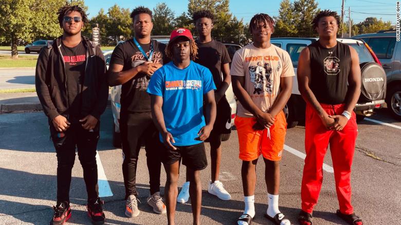 'We just did the right thing.' A group of high school football players rescued an injured woman trapped in her car after a wreck