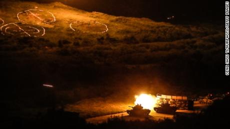 Tanks fire projectiles during a Taiwanese military live-fire drill, after Beijing increased its military exercises near Taiwan in September.