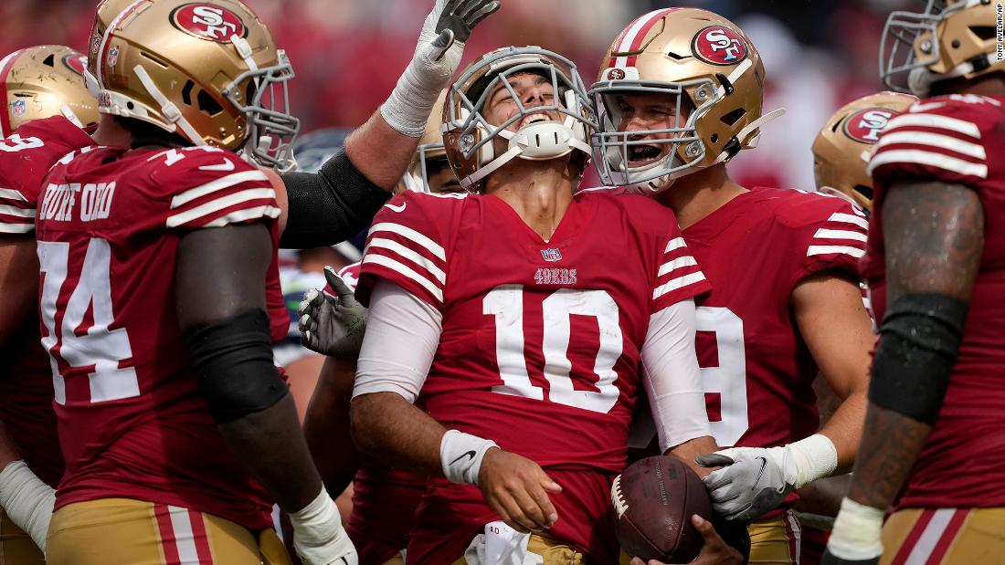 San Francisco 49ers quarterback Jimmy Garoppolo celebrates with his teammates during the second half of a 27-7 win against the Seattle Seahawks on September 18. Garoppolo came on as a substitute after starter Trey Lance went down for the year with a fractured ankle and threw for 154 yards and one touchdown -- and rushed for another -- on 13/21 passing.