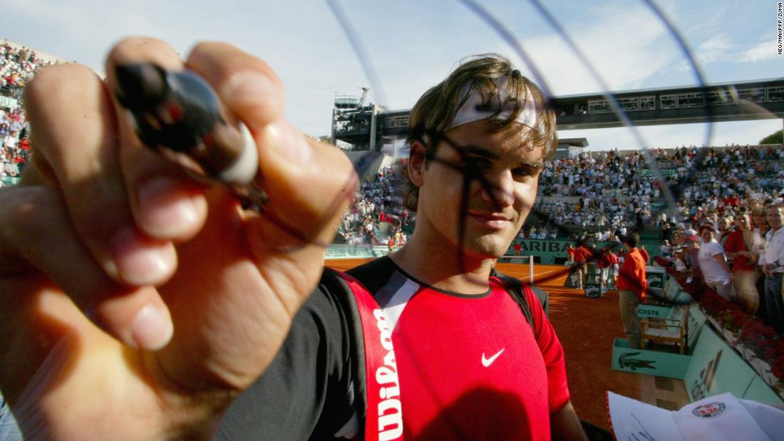 Federer signs a camera after a French Open match in 2005.