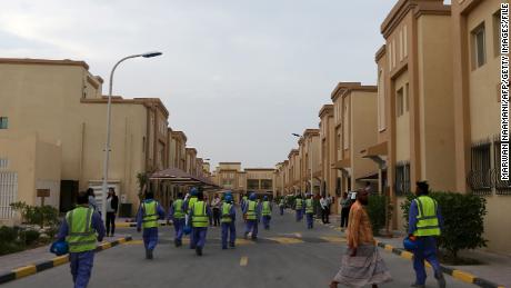 Foreign laborers working on the construction site of the Al-Wakrah football stadium, one of Qatar&#39;s 2022 World Cup stadiums, walk back to their accomodation at the Ezdan 40 compound after finishing work on May 4, 2015, in Doha&#39;s Al-Wakrah southern suburbs. 